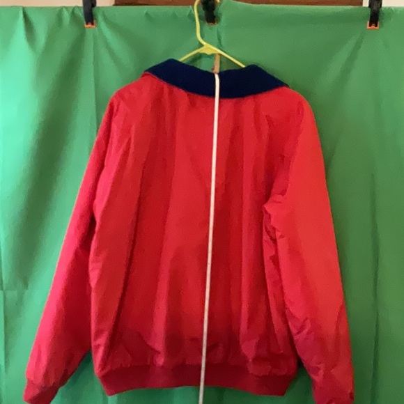 Bright red windbreaker with navy blue fleece lining and insulated sleeves. - Picture 6 of 11